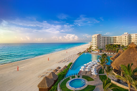Aerial view of an oceanfront hotel showcasing beachfront setting and resort layout for hospitality marketing.