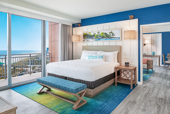 Guest room interior highlighting layout, finishes, and balcony views designed for comfort and experience.