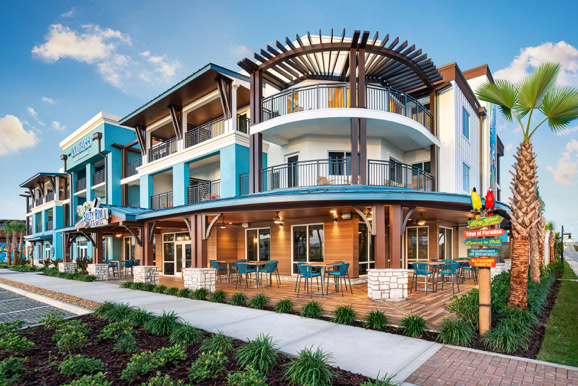 Multi-level resort exterior highlighting architectural design, materials, and landscaped surroundings.