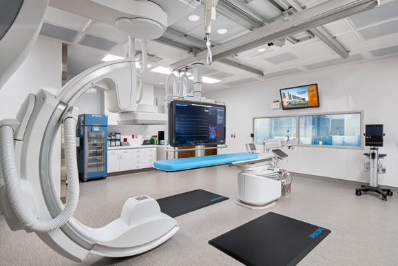 Advanced surgical suite featuring medical technology and clean, controlled clinical design.