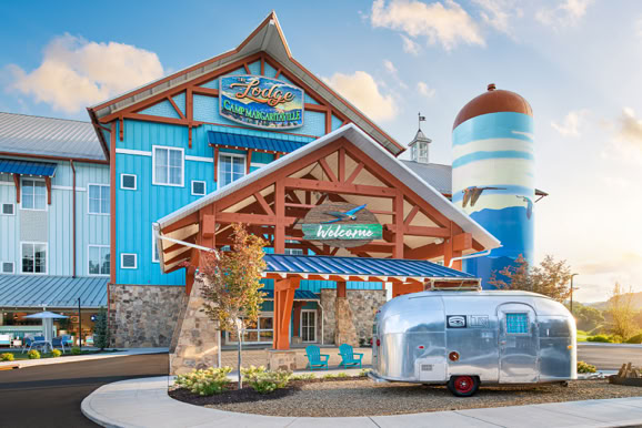 Exterior entrance of a mountain Lodge hospitality venue showcasing branding, architecture, and guest arrival experience.